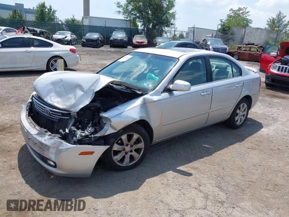 ✅ 2007 Kia Optima LX • VIN: KNAGE123075147295 • Лот: 42873441. Опубликован ранее на IAAI с пробегом 126 809 миль. Бесплатный доступ к архиву аукционных продаж из США и подробный отчёт об истории автомобиля на DreamBid. Изображение 2.