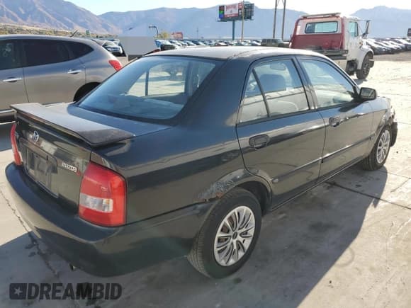 ✅ 2000 Mazda Protege DX • VIN: JM1BJ2220Y0239835 • Lot: 80228864. Wystawiony na Copart z przebiegiem 200 936 mil. Bezpłatny archiwum sprzedaży aukcyjnych z USA i szczegółowy raport historii pojazdu na DreamBid. Zdjęcie 3.