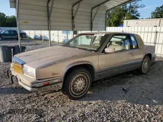 ✅ 1991 Cadillac Eldorado • VIN: 1G6EL13BXMU605841 • Lot: 66441585. Wystawiony na Copart z przebiegiem 75 827 mil. Bezpłatny archiwum sprzedaży aukcyjnych z USA i szczegółowy raport historii pojazdu na DreamBid. Zdjęcie 1.