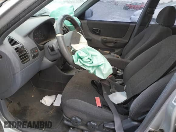 2002 Hyundai Accent GL with VIN KMHCG45C02U301443, listed as a Copart auction lot 80670164 with 124,163 mi miles and Salvage title. Bid and sale history available at DreamBid. Image 7.