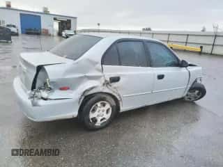 2002 Hyundai Accent GL with VIN KMHCG45C02U301443, listed as a Copart auction lot 80670164 with 124,163 mi miles and Salvage title. Bid and sale history available at DreamBid. Image 3.