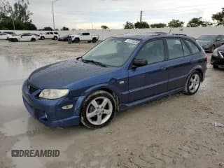 ✅ 2003 Mazda Protege • VIN: JM1BJ245931128629 • Лот: 81700205. Опубликован ранее на Copart с пробегом 107 189 миль. Бесплатный доступ к архиву аукционных продаж из США и подробный отчёт об истории автомобиля на DreamBid. Изображение 1.