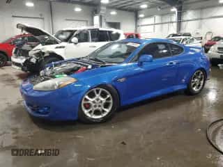 2007 Hyundai Tiburon GT z VIN KMHHN66F07U254955, wystawiony jako Copart lot #82239034 z przebiegiem 193 900 mil mil oraz Szkoda całkowita • Salvage title. Historia ofert i sprzedaży dostępna na DreamBid. Obrazek 1.