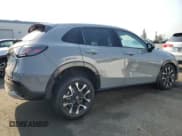 ✅ 2026 Honda HR-V EX-L • VIN: 3CZRZ1H77TM704115 • Лот: 64620495. Опубликован ранее на Copart с пробегом 1 285 миль. Бесплатный доступ к архиву аукционных продаж из США и подробный отчёт об истории автомобиля на DreamBid. Изображение 3.