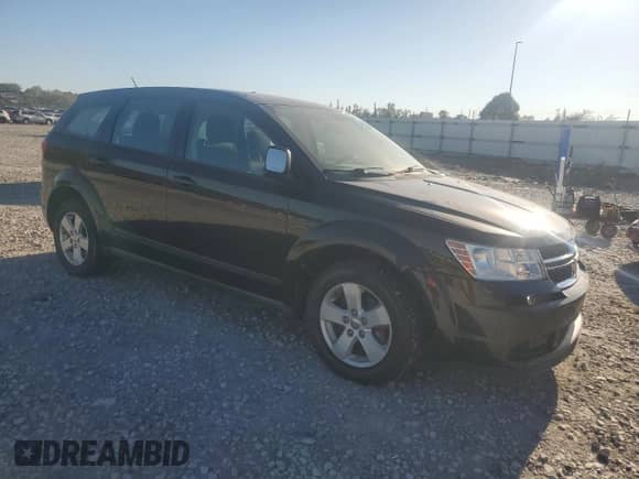 2013 Dodge Journey American Value with VIN 3C4PDCAB5DT597224, listed as a Copart auction lot 82536665 with 104,666 mi miles and Clean title. Bid and sale history available at DreamBid. Image 4.