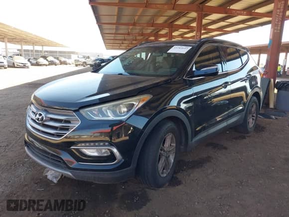 2018 Hyundai Santa Fe 2.4L z VIN 5NMZU3LB8JH066582, wystawiony jako IAAI lot #43283643 z przebiegiem 117 648 mil mil oraz . Historia ofert i sprzedaży dostępna na DreamBid. Obrazek 2.