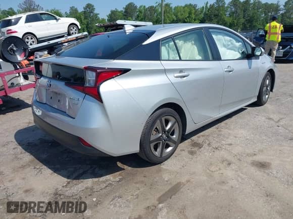 2021 Toyota Prius L Eco with VIN JTDKAMFU5M3137298, listed as a IAAI auction lot 42270937 with 38,828 mi miles and . Bid and sale history available at DreamBid. Image 4.