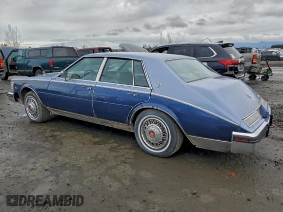 ✅ 1984 Cadillac Seville • VIN: 1G6AS6989EE809567 • Лот: 94370185. Опубликован ранее на Copart с пробегом 1 116 миль. Бесплатный доступ к архиву аукционных продаж из США и подробный отчёт об истории автомобиля на DreamBid. Изображение 2.