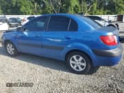 ✅ 2009 Kia Rio LX • VIN: KNADE223296515613 • Лот: 62008194. Опубликован ранее на Copart с пробегом 143 238 миль. Бесплатный доступ к архиву аукционных продаж из США и подробный отчёт об истории автомобиля на DreamBid. Изображение 2.