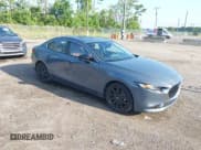 ✅ 2024 Mazda 3 S Carbon Edition • VIN: 3MZBPBCM6RM411828 • Lot: 42802141. Listed on IAAI with 40,061 mi. Free auction sales archive from the USA and detailed vehicle history report at DreamBid. Image 1.