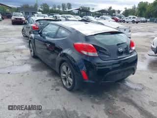 2012 Hyundai Veloster w/Gray Int z VIN KMHTC6AD6CU049429, wystawiony jako IAAI lot #43410430 z przebiegiem 153 050 mil mil oraz . Historia ofert i sprzedaży dostępna na DreamBid. Obrazek 3.