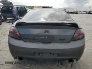 2007 Hyundai Tiburon GS z VIN KMHHM66D47U243846, wystawiony jako Copart lot #57509725 z przebiegiem 181 941 mil mil oraz Szkoda całkowita • Salvage title. Historia ofert i sprzedaży dostępna na DreamBid. Obrazek 6.