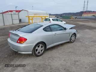 2004 Hyundai Tiburon GS z VIN KMHHM65D24U135433, wystawiony jako IAAI lot #41001291 z przebiegiem Nie podano mil oraz . Historia ofert i sprzedaży dostępna na DreamBid. Obrazek 4.