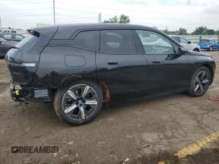 ✅ 2024 BMW iX xDrive50 • VIN: WB523CF01RCN55992 • Лот: 59352604. Опубликован ранее на Copart с пробегом 8 415 миль. Бесплатный доступ к архиву аукционных продаж из США и подробный отчёт об истории автомобиля на DreamBid. Изображение 3.