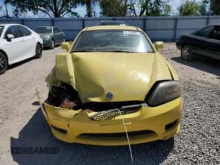 2006 Hyundai Tiburon GT z VIN KMHHN65F96U203308, wystawiony jako Copart lot #47278684 z przebiegiem 186 123 mil mil oraz Szkoda całkowita • Salvage title. Historia ofert i sprzedaży dostępna na DreamBid. Obrazek 5.