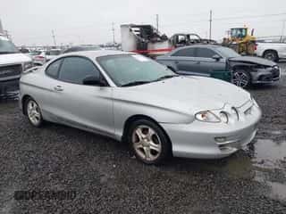 2001 Hyundai Tiburon z VIN KMHJG25F81U267658, wystawiony jako IAAI lot #41092438 z przebiegiem 188 575 mil mil oraz . Historia ofert i sprzedaży dostępna na DreamBid. Obrazek 1.