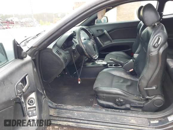 2007 Hyundai Tiburon GT z VIN KMHHN66F37U250320, wystawiony jako IAAI lot #42047654 z przebiegiem 231 899 mil mil oraz . Historia ofert i sprzedaży dostępna na DreamBid. Obrazek 5.