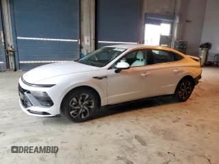 ✅ 2025 Hyundai Sonata SEL • VIN: KMHL64JA1SA487194 • Лот: 91126385. Опубликован ранее на Copart с пробегом 14 131 миль. Бесплатный доступ к архиву аукционных продаж из США и подробный отчёт об истории автомобиля на DreamBid. Изображение 1.