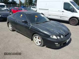 2000 Hyundai Tiburon z VIN KMHJG35F5YU191588, wystawiony jako IAAI lot #41934653 z przebiegiem 161 590 mil mil oraz . Historia ofert i sprzedaży dostępna na DreamBid. Obrazek 1.