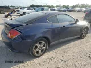 2003 Hyundai Tiburon z VIN KMHHM65D03U095741, wystawiony jako Copart lot #55147305 z przebiegiem 170 946 mil mil oraz Szkoda całkowita • Salvage title. Historia ofert i sprzedaży dostępna na DreamBid. Obrazek 3.