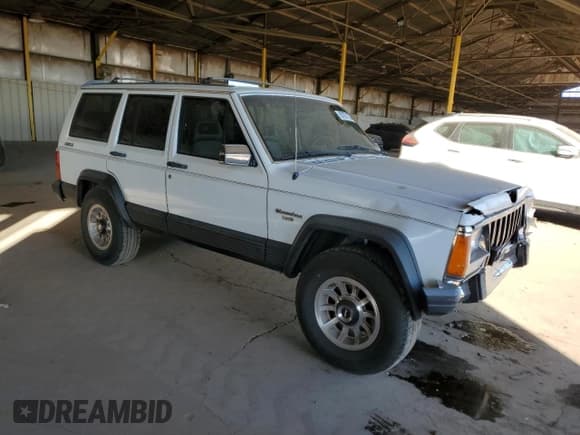 ✅ 1990 Jeep Cherokee Laredo • VIN: 1J4FJ58L8LL282842 • Lot: 87071724. Listed on Copart with 232,415 mi. Free auction sales archive from the USA and detailed vehicle history report at DreamBid. Image 4.