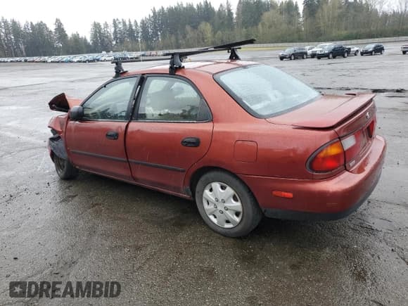 ✅ 1997 Mazda Protege DX • VIN: JM1BC1415V0146345 • Lot: 51526825. Listed on Copart with 245,314 mi. Free auction sales archive from the USA and detailed vehicle history report at DreamBid. Image 2.
