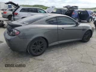 2007 Hyundai Tiburon GS z VIN KMHHM66D47U243846, wystawiony jako Copart lot #57509725 z przebiegiem 181 941 mil mil oraz Szkoda całkowita • Salvage title. Historia ofert i sprzedaży dostępna na DreamBid. Obrazek 3.