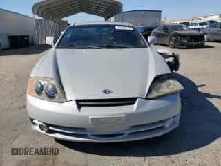 2003 Hyundai Tiburon GT с VIN KMHHN65F73U101856, выставлен на аукционе Copart как лот 64248815 с пробегом 59 622 миль миль и Списание • Salvage title. История ставок и продаж доступна на DreamBid. Изображение 5.