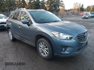 ✅ 2016 Mazda CX-5 Touring • VIN: JM3KE4CY1G0885510 • Lot: 43653537. Wystawiony na IAAI z przebiegiem 70 619 mil. Bezpłatny archiwum sprzedaży aukcyjnych z USA i szczegółowy raport historii pojazdu na DreamBid. Zdjęcie 1.