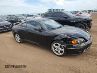 2004 Hyundai Tiburon GT с VIN KMHHN65F54U112663, выставлен на аукционе Copart как лот 60543975 с пробегом 51 589 миль миль и Списание • Salvage title. История ставок и продаж доступна на DreamBid. Изображение 4.
