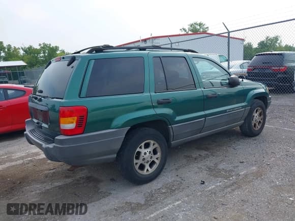 ✅ 1999 Jeep Grand Cherokee Laredo • VIN: 1J4G258S5XC543617 • Lot: 39937200. Listed on IAAI with 133,461 mi. Free auction sales archive from the USA and detailed vehicle history report at DreamBid. Image 4.