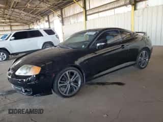 2003 Hyundai Tiburon GT z VIN KMHHN65F23U021493, wystawiony jako Copart lot #68441584 z przebiegiem 92 848 mil mil oraz Czysty tytuł • Clean title. Historia ofert i sprzedaży dostępna na DreamBid. Obrazek 1.