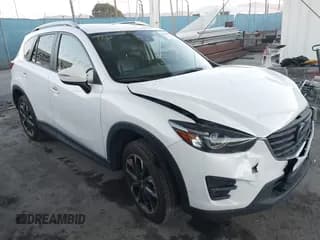 ✅ 2016 Mazda CX-5 Grand Touring • VIN: JM3KE2DY3G0863303 • Lot: 43848862. Wystawiony na IAAI z przebiegiem 95 498 mil. Bezpłatny archiwum sprzedaży aukcyjnych z USA i szczegółowy raport historii pojazdu na DreamBid. Zdjęcie 1.