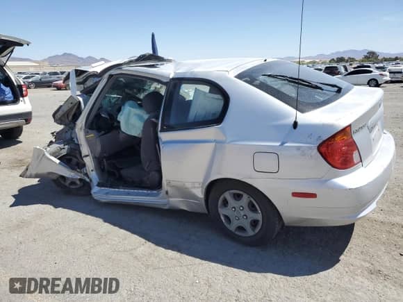 2005 Hyundai Accent GLS with VIN KMHCG35C05U323148, listed as a Copart auction lot 54077465 with 59,182 mi miles and Salvage title. Bid and sale history available at DreamBid. Image 2.