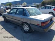 ✅ 1990 Toyota Camry DLX • VIN: 4T1SV21E6LU257382 • Lot: 41848382. Wystawiony na IAAI z przebiegiem 322 005 mil. Bezpłatny archiwum sprzedaży aukcyjnych z USA i szczegółowy raport historii pojazdu na DreamBid. Zdjęcie 3.