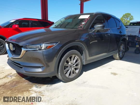 ✅ 2021 Mazda CX-5 Grand Touring • VIN: JM3KFADM9M1381655 • Lot: 43436750. Wystawiony na IAAI z przebiegiem 64 217 mil. Bezpłatny archiwum sprzedaży aukcyjnych z USA i szczegółowy raport historii pojazdu na DreamBid. Zdjęcie 2.