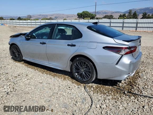 ✅ 2022 Toyota Camry Hybrid Nightshade • VIN: 4T1G31AK7NU033150 • Лот: 84897285. Опубликован ранее на Copart с пробегом 210 059 миль. Бесплатный доступ к архиву аукционных продаж из США и подробный отчёт об истории автомобиля на DreamBid. Изображение 2.