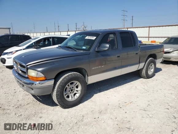 2001 Dodge Dakota Sport z VIN 1B7HL2AN61S301927, wystawiony jako Copart lot #74676094 z przebiegiem 228 616 mil mil oraz Szkoda całkowita • Salvage title. Historia ofert i sprzedaży dostępna na DreamBid. Obrazek 1.