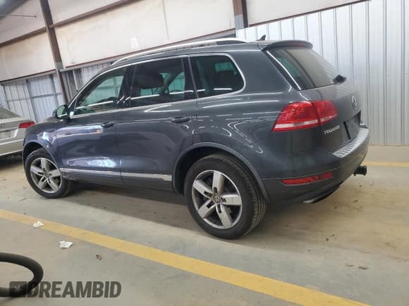 ✅ 2012 Volkswagen Touareg Sport • VIN: WVGEF9BP4CD011854 • Lot: 93265865. Listed on Copart with 143,711 mi. Free auction sales archive from the USA and detailed vehicle history report at DreamBid. Image 2.