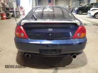 2003 Hyundai Tiburon GT z VIN KMHHN65F43U075197, wystawiony jako Copart lot #52617655 z przebiegiem 117 561 mil mil oraz Szkoda całkowita • Salvage title. Historia ofert i sprzedaży dostępna na DreamBid. Obrazek 6.