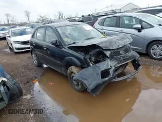 ✅ 2010 Kia Rio LX • VIN: KNADH5A3XA6652622 • Lot: 41904735. Listed on IAAI with 137,516 mi. Free auction sales archive from the USA and detailed vehicle history report at DreamBid. Image 1.