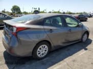 ✅ 2021 Toyota Prius L Eco • VIN: JTDKAMFU1M3152705 • Лот: 70772215. Опубликован ранее на Copart с пробегом 64 502 миль. Бесплатный доступ к архиву аукционных продаж из США и подробный отчёт об истории автомобиля на DreamBid. Изображение 3.
