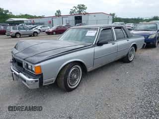 1986 Chevrolet Caprice z VIN 1G1BN69H5GY139096, wystawiony jako IAAI lot #42658175 z przebiegiem 124 000 mil mil oraz . Historia ofert i sprzedaży dostępna na DreamBid. Obrazek 2.