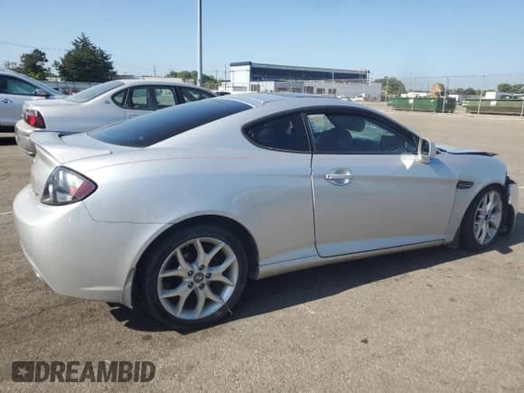2008 Hyundai Tiburon GT z VIN KMHHN66F08U267030, wystawiony jako Copart lot #67479764 z przebiegiem Nie podano mil oraz Szkoda całkowita • Salvage title. Historia ofert i sprzedaży dostępna na DreamBid. Obrazek 3.