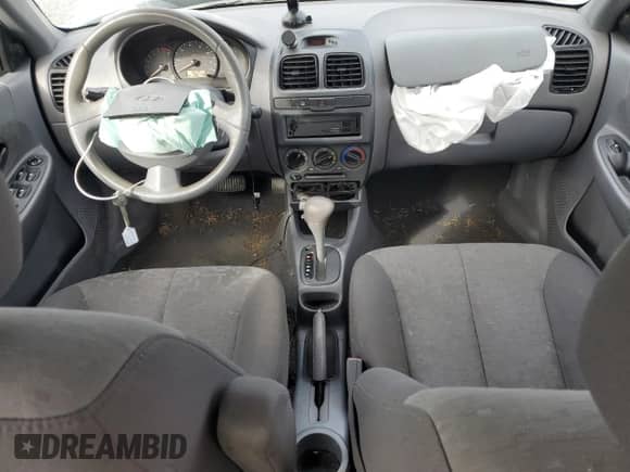 2003 Hyundai Accent GL z VIN KMHCG45C63U485420, wystawiony jako Copart lot #48251265 z przebiegiem 139 179 mil mil oraz Szkoda całkowita • Salvage title. Historia ofert i sprzedaży dostępna na DreamBid. Obrazek 8.