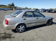 ✅ 2002 Mazda Protege DX • VIN: JM1BJ225921589573 • Lot: 82300865. Wystawiony na Copart z przebiegiem 108 594 mil. Bezpłatny archiwum sprzedaży aukcyjnych z USA i szczegółowy raport historii pojazdu na DreamBid. Zdjęcie 3.