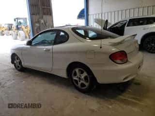 2000 Hyundai Tiburon z VIN KMHJG25F1YU217419, wystawiony jako Copart lot #54772515 z przebiegiem 155 023 mil mil oraz Szkoda całkowita • Salvage title. Historia ofert i sprzedaży dostępna na DreamBid. Obrazek 2.