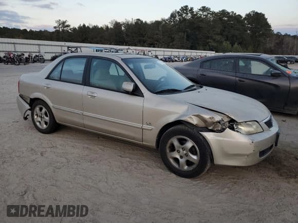 ✅ 2001 Mazda Protege LX • VIN: JM1BJ225310467814 • Lot: 77675414. Listed on Copart with Not provided. Free auction sales archive from the USA and detailed vehicle history report at DreamBid. Image 4.