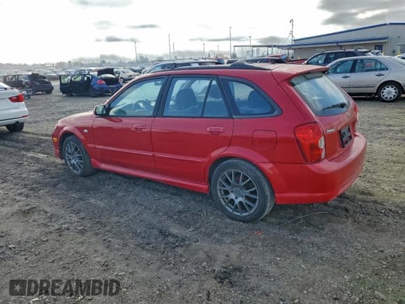 ✅ 2002 Mazda Protege • VIN: JM1BJ245521616264 • Lot: 95169045. Listed on Copart with 111,622 mi. Free auction sales archive from the USA and detailed vehicle history report at DreamBid. Image 2.
