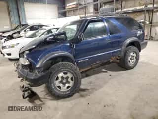 2001 Chevrolet Blazer LS z VIN 1GNCT18W01K143093, wystawiony jako Copart lot #82650514 z przebiegiem Nie podano mil oraz Szkoda całkowita • Salvage title. Historia ofert i sprzedaży dostępna na DreamBid. Obrazek 1.